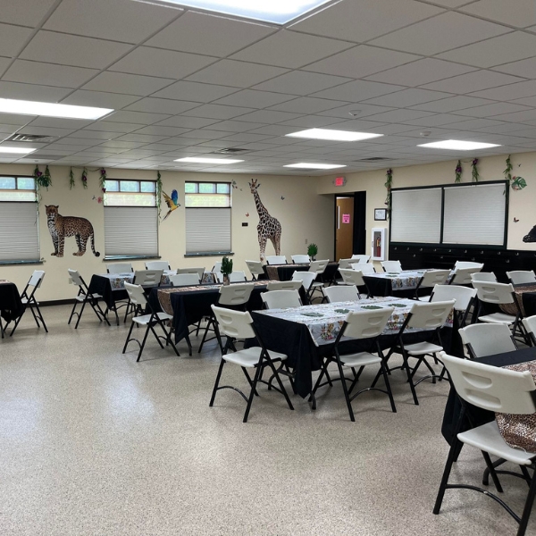 Tables and chairs set up in party room