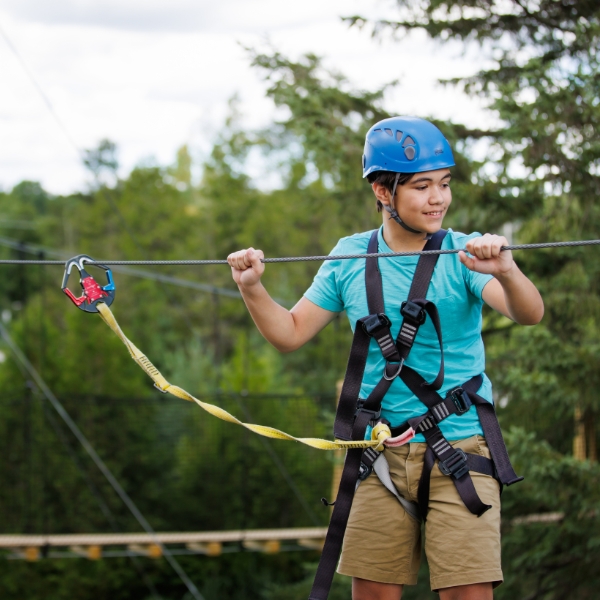 child smiling on the ropes course