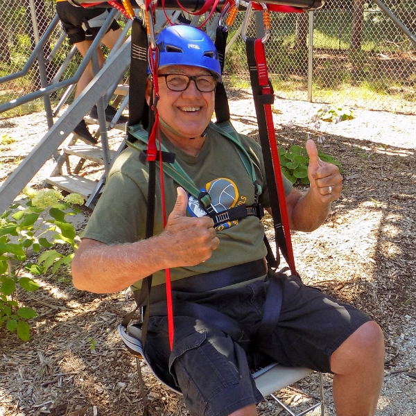 Zipliner sitting in adaptable harness