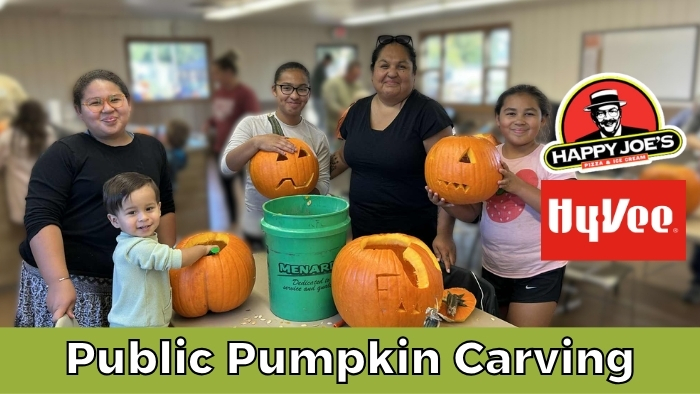 Public Pumpkin Carving event header shows a family standing in front of a row of carved pumpkins